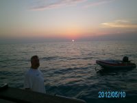16 Bradley and our small tender at sunset in Staniel&nbsp;Cay