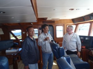 Bradley talks to Taiwainese boat builders aboard Shear Madness